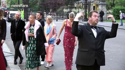 Model Lily Donaldson has trouble getting up stairs in long dress at British Vogue 100 Gala Dinner