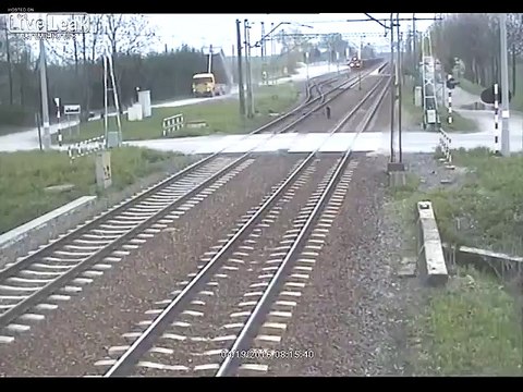 Truck tries to cross train tracks with its trailer up