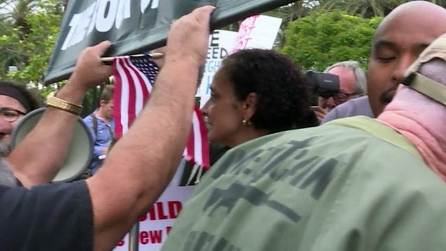 Pro and anti-Trump protesters confront each other outside rally