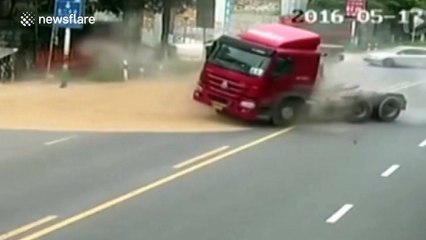 Motorbike driver escapes being buried by sand pouring out of trailer
