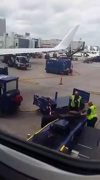 Baggage handlers curl passengers' luggage