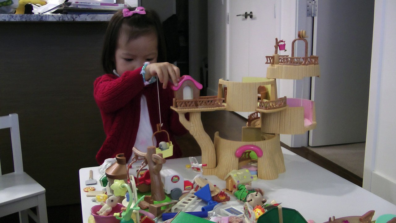 Girl Playing Sylvanian Families Baby Tree House