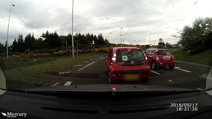 New driver stalls THIRTEEN times trying to negotiate busy roundabout in painful dashcam footage