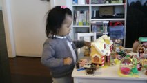 Girl Setting Up Her Sylvanian Families Gingerbread House