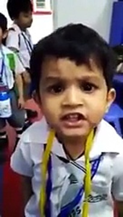 Cute Boy Singing in class in front of teacher