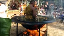 A Buddhist monk meditating in a hot oil container