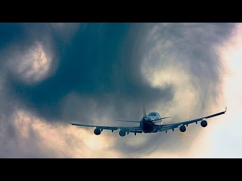 Airplane Flying Into Low Cloud Cover Creates Vortex and Swirls