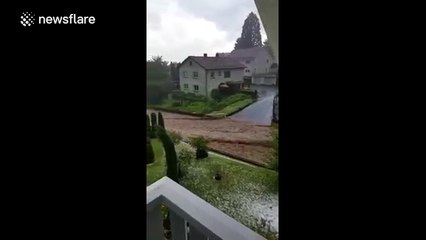 Floodwater flows through German town after storm