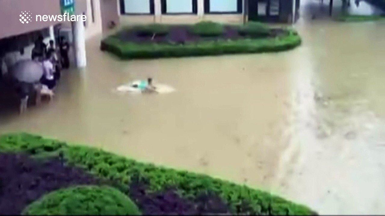 Student swims in floodwater in southeastern China