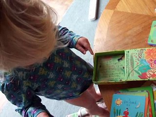 Little girl playing with affirmation cards