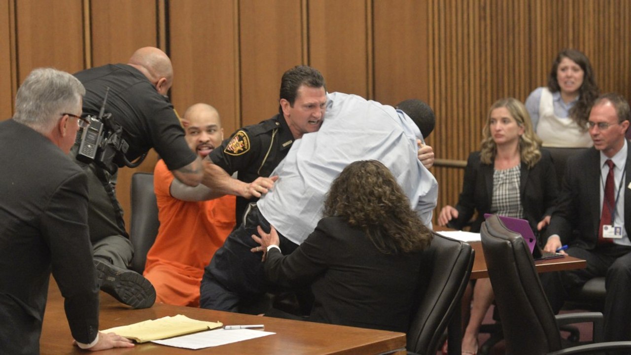 Father lunges at his daughter's killer in court