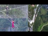 Tightrope walkers race across wire suspended between mountains