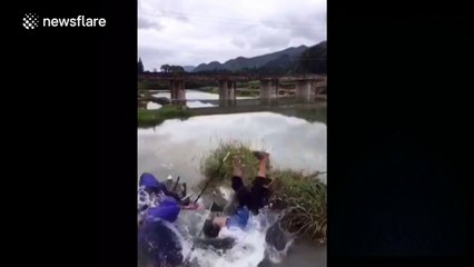 Fisherman catches friend's head with his net and makes him fall