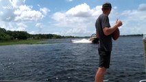 Man catches American football while doing a backflip on a wakeboard