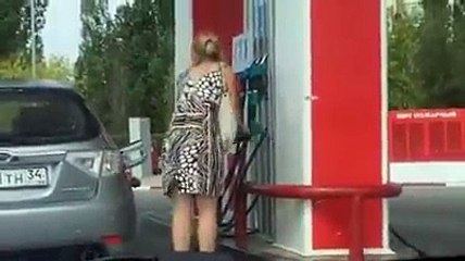 Une femme dans une station essence...