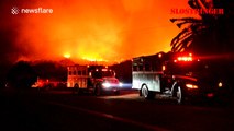 Fire brigade protect houses from vegetation fire in California