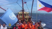 S China Sea: Filipino activists raise national flag on disputed island
