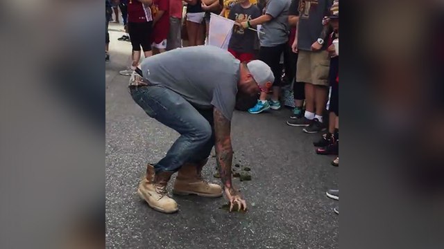 Un supporter des Cavs mange du crottin de cheval pendant la parade