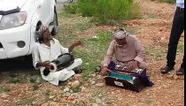 Gumnaan artists performing on a road side at QA university.