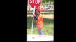 North Carolina road worker sleeping while holding road sign.