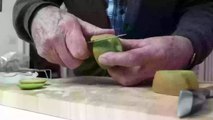 Peeling a Kiwi fruit.