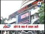 Sensex ends at 18,000