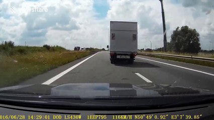 Lorry side panel smashes onto car