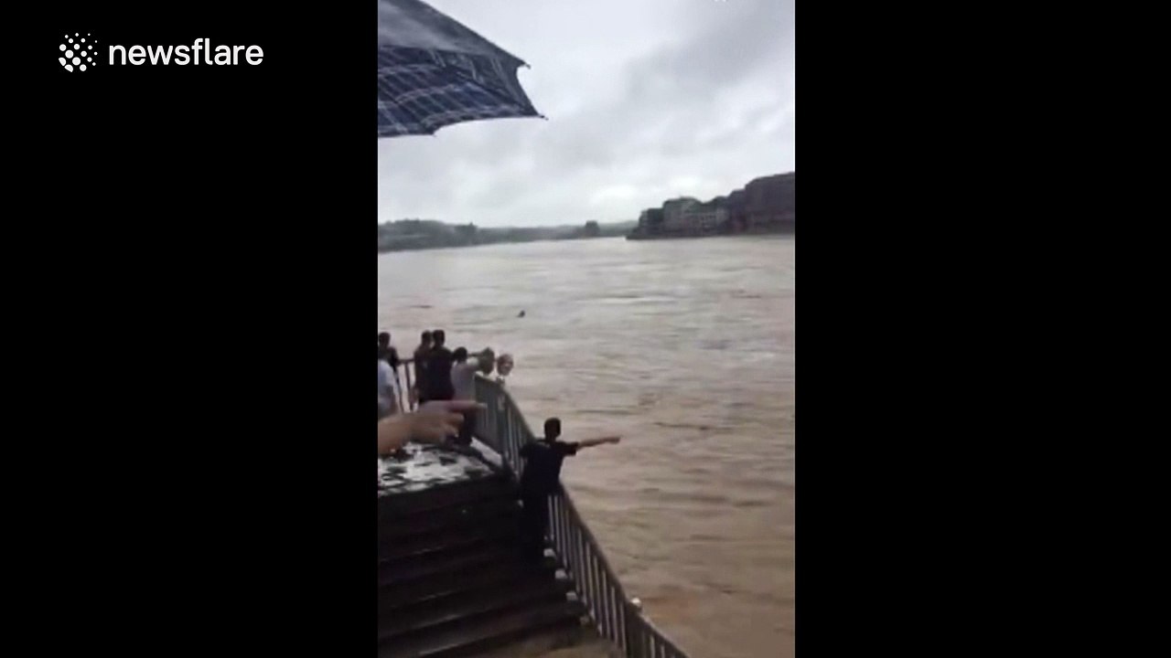 Police officer swept away by floods saved after being dragged down river