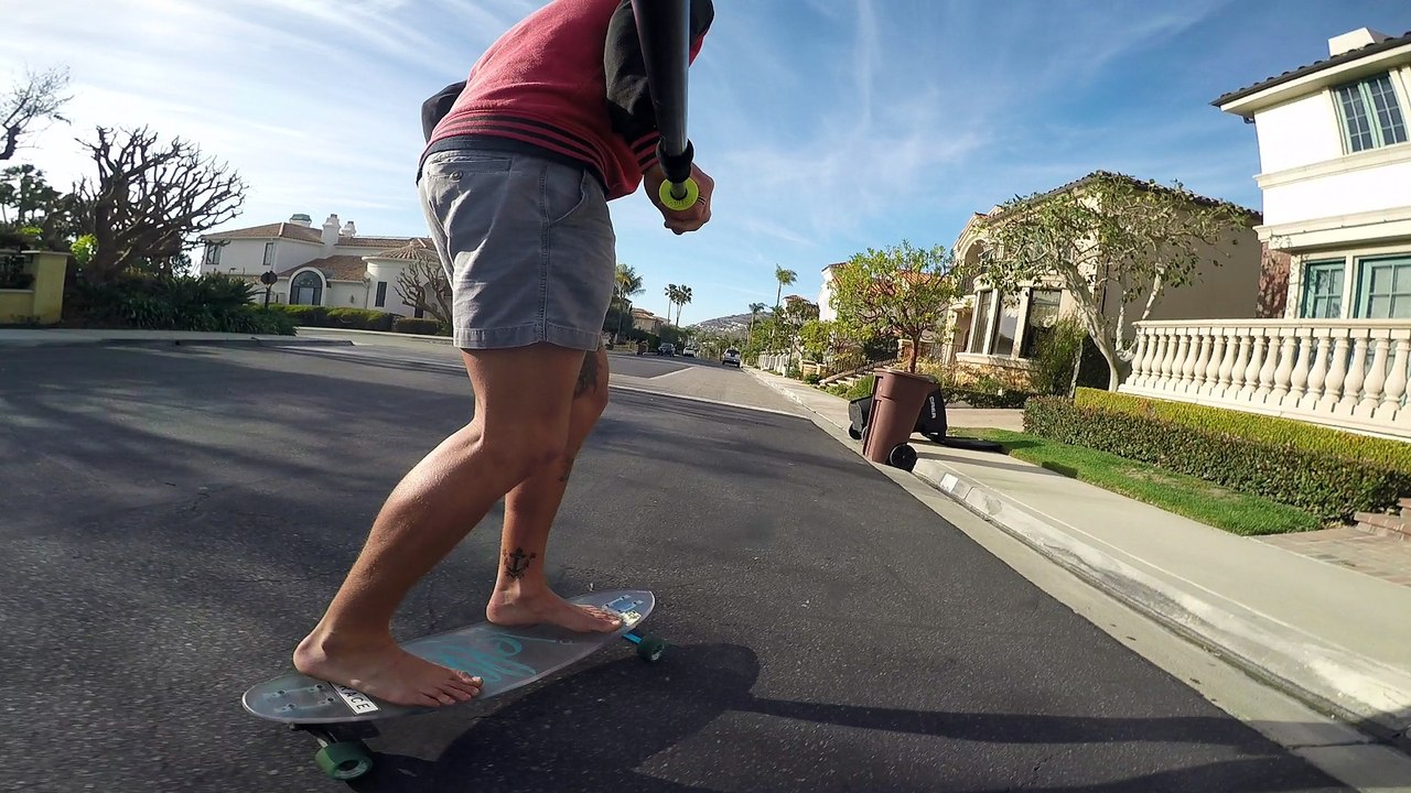 Bombing Hills on a Clear Longboard Skateboard Barefoot