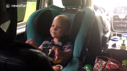 Twin babies dance to rock music during car trip