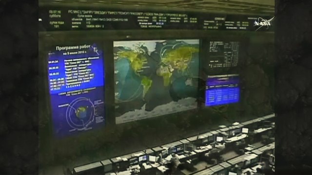 Spaceship carrying three-man crew docks with space station