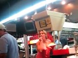 Drunk girl argues with a group of guys, throws fries at them