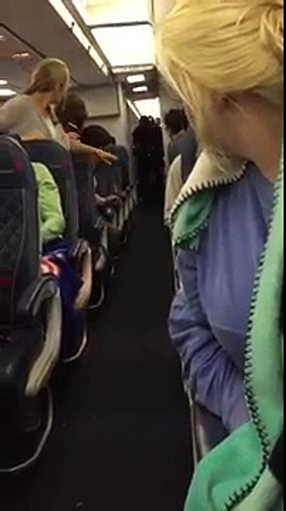 "You're stepping on my hair!" Drunk girl gets dragged off of plane