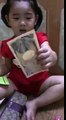 Cute baby trying to open her mom's wallet