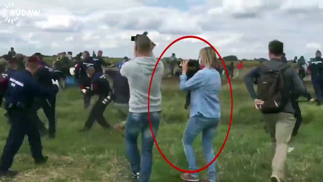 Hungarian camerawoman filming police chase of refugees trips refugee