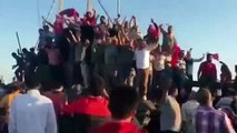 Turkish People celebrate on top of tanks near the Bosphorus bridge