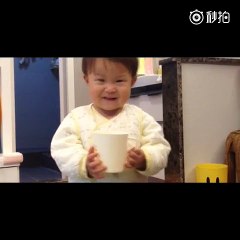 A small kid gives water from toilet to his father