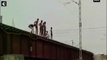 Young boys jump off bridge seconds before train passes through