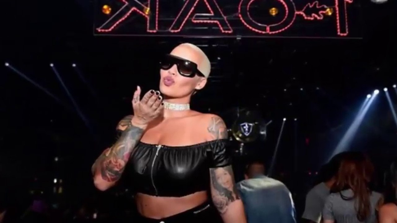 Amber Rose models as she keeps her sunglasses on inside zip up leather extreme crop top