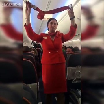 Football fans on flight distracting the air hostess doing the safety announcement