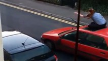 Video shows woman attacking, jumping on car before it drives off with her on the roof, UK