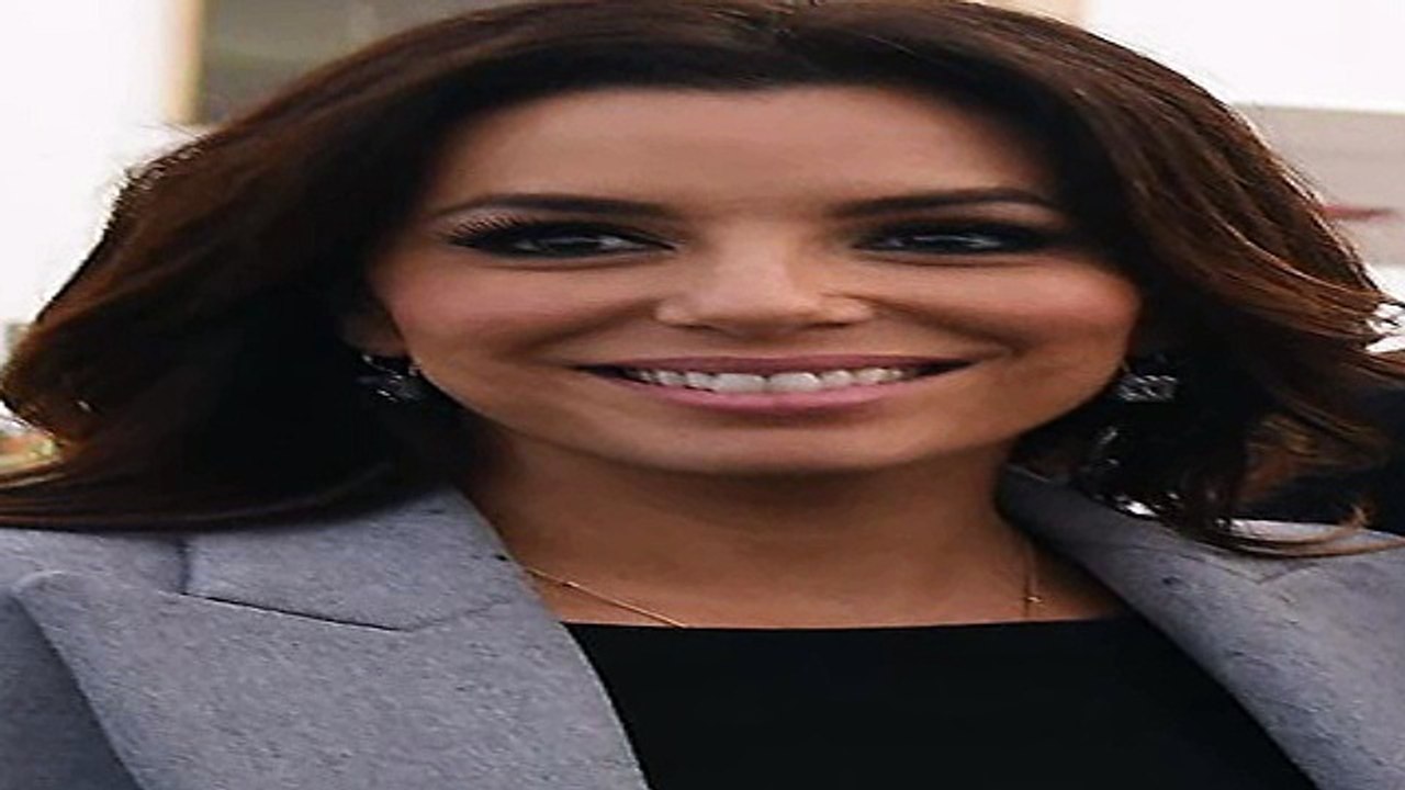 Eva Longoria awkwardly strolls alongside naked beach goers in Ibiza