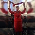 Football fans on flight distracting the air hostess doing the safety announcement