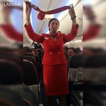 Football fans on flight distracting the air hostess doing the safety announcement
