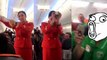 Football Fans Hilariously Distract Flight Attendant Who Can Barely Get Through Her Job