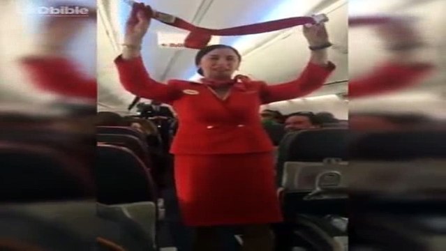 Football fans on flight distracting the air hostess doing the safety announcement
