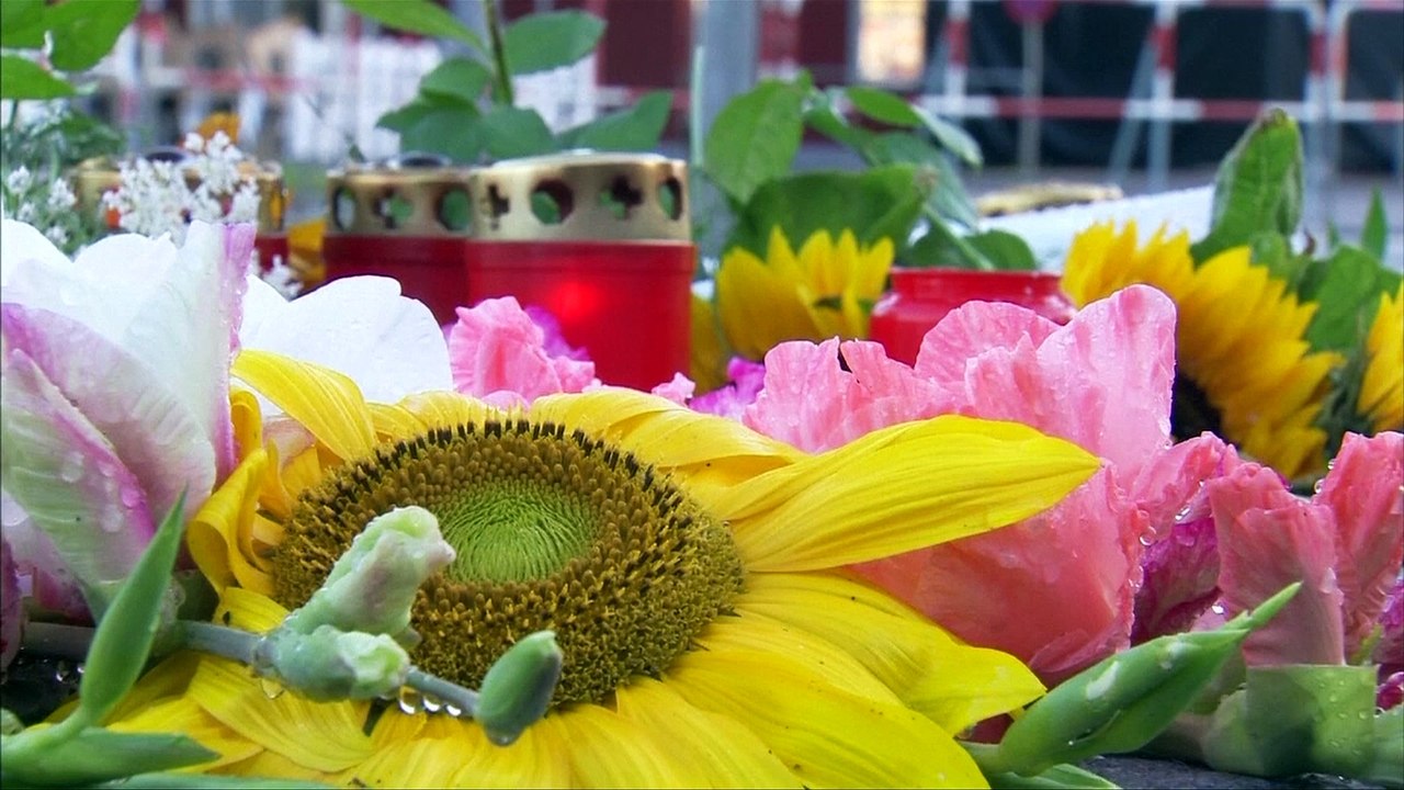 Flowers and candles placed at scene of shopping mall shooting in Munich