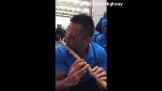 Dhoni playing flute at the Airport watch it.