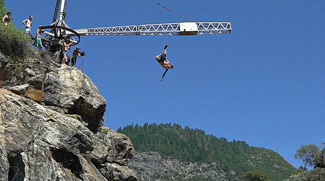 Daredevils Jump 80-Feet From Crane Placed On Cliff