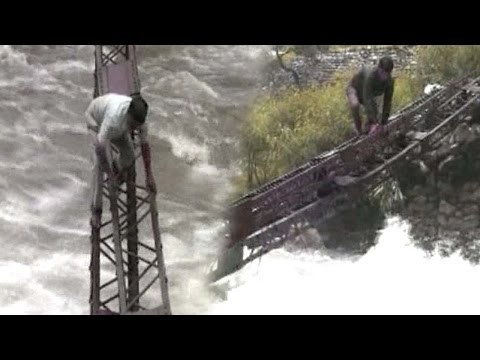 Watch | Uttarkashi villagers risk life, cross trench with flood water on overhead rail